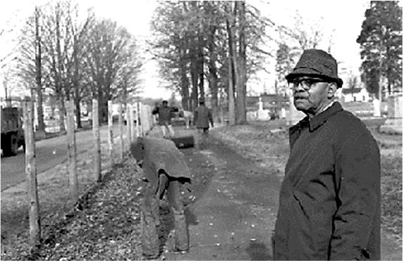 Fred Alexander Watches Fence Separating Elmwood And Pinewood Cemeteries Being Removed On January 7, 1969.