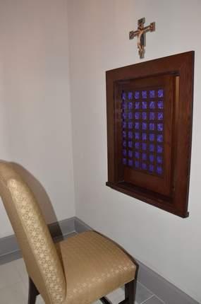 Confessional Furnishings, crucifix, and stained wood sliding screen