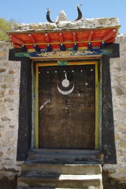 Slide 6 Indigenous Religious Tradition in Tibet Buddhism Meets Bön Door in Tibet with Bön religious symbolism Image