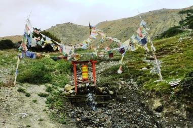 Slide 9 An elderly Tibetan woman with a prayer wheel Prayer Wheels Water-powered