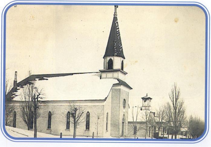 A wonderful winter photograph of the Swedish Lutheran Church and the schoolhouse next door. The photographer's angle allows one to appreciate the view looking east down Danaher Street.