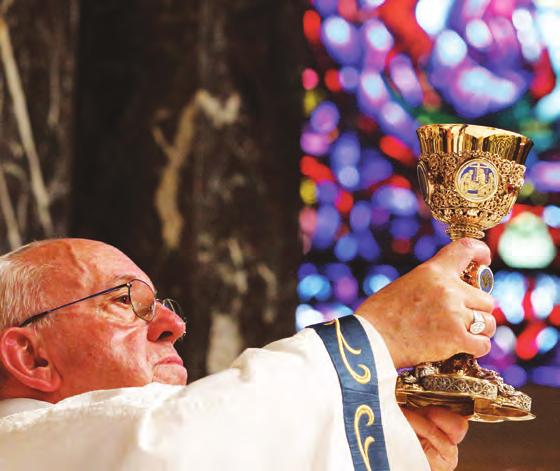 2 CNS photo by Paul Haring Pope Francis raises the chalice of the Precious Blood at the Cathedral Basilica of SS. Peter and Paul in Philadelphia.