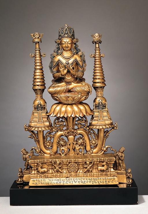 Brass image of the Buddha Vairochana, from Kashmir Buddha surrounded by familiar symbols but with great richness and elaboration.elaborate crown and garment with silver inlay.