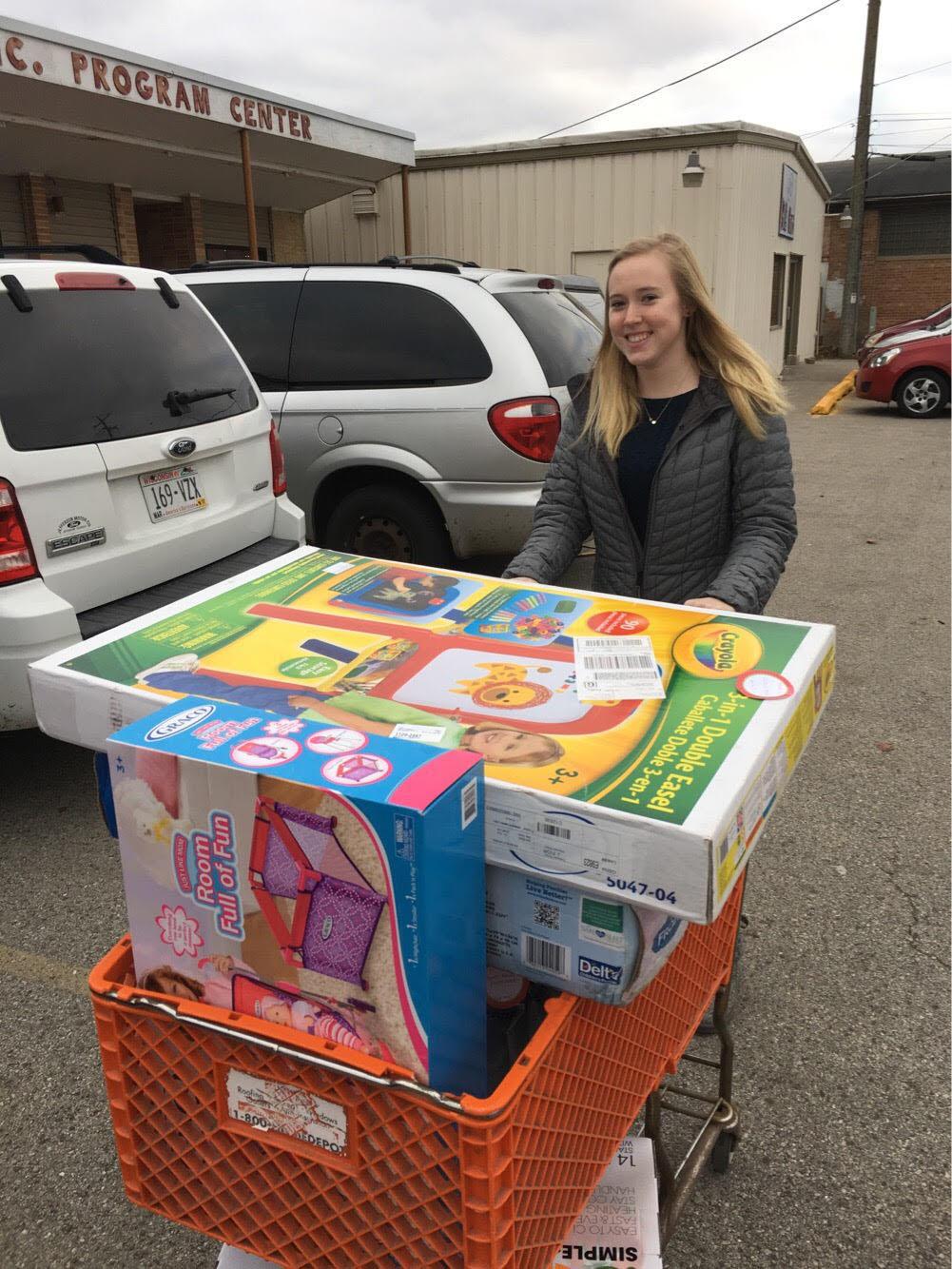 All presents will be distributed to the parents soon from Love Inc. Pictured is Key Club president Jaclyn delivering the Adopt-a-Family presents to Love Inc.