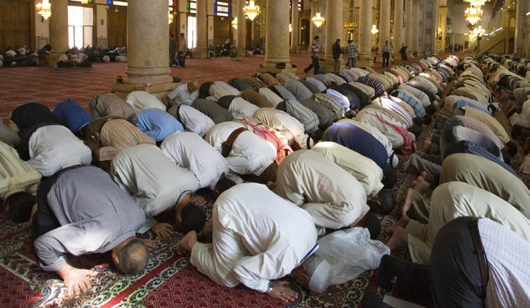 Muslims kneel in prayer five times a day.