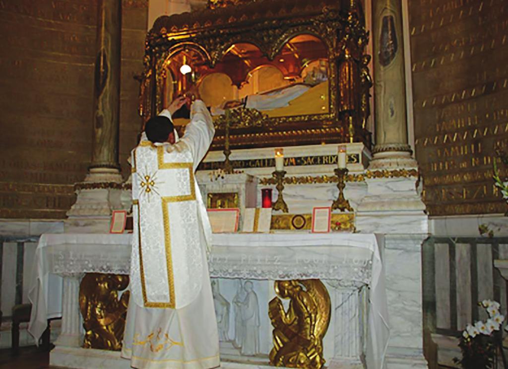 Above, Father Michael Rodriguez offering the Tridentine Mass at the altar which holds the incorrupt body of St. John Marie Vianney in Ars, France.