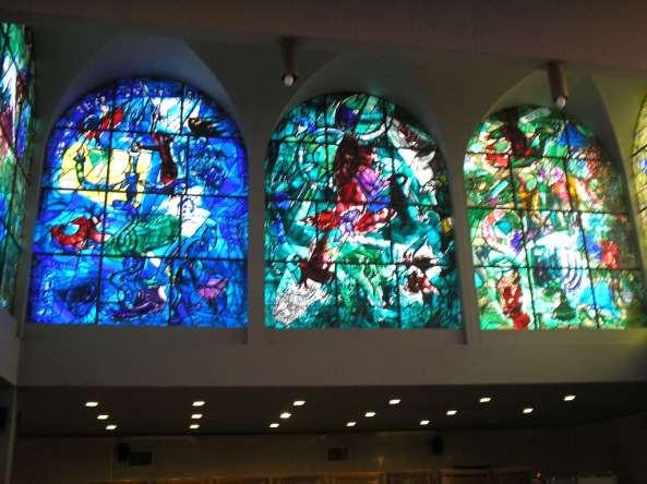 Chagall Windows - Dan, Gad, Asher -- Tradition associates each of the tribes with a symbol, a precious stone and a social role. WESTERN VIEW (view from inside the building) 1.
