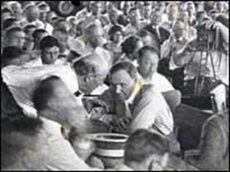 A cameraman (far right) captures Bryan and Darrow conferring during the trial.