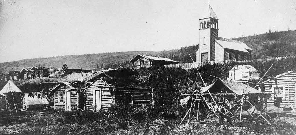 Helping Us Learn and Remember Moosehide village, circa 1910-1920. Courtesy the Anglican Church of Canada, General Synod Archives Toronto, Thomas Camham Collection, P7510.