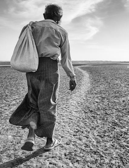 Displaced by anti-rohingya violence, a Rohingya man walks alone outside Sittwe,