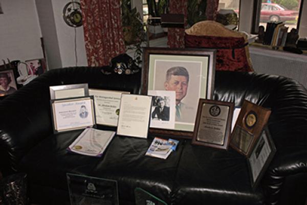 President John F. Kennedy's photo is prominent among the awards Bolden has received over the years promoting his book about racism in the U.S.