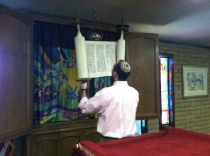 Take the sash or fastener, and fasten it around the front of the Torah (the part with the writing) 4.