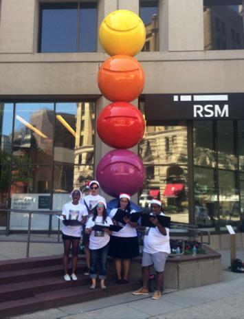 2017 Cast Members sing carols to promote A Christmas Carol in Downtown Milwaukee for Christmas in July.
