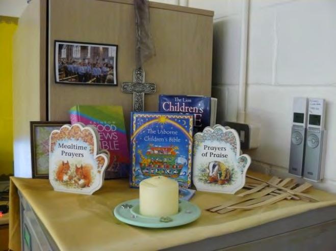 and in the classroom A small display of books used in everyday worship, with a candle and a cross - a permanent reminder