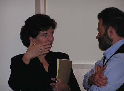 Host Tad Taube and Janusz Makuch listen carefully to the presentations. Dr. Anita Friedman engages Janusz Makuch in a follow-up conversation.