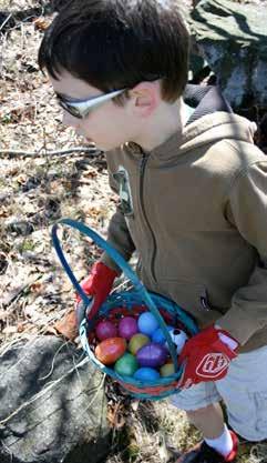 Happy hunters scrambled around the picnic field searching for candy filled eggs, while keeping an extra