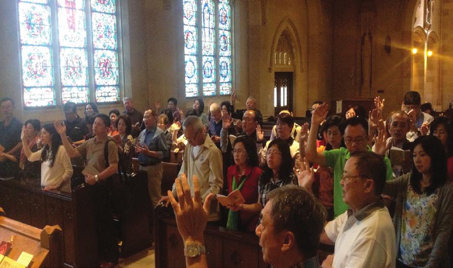 April Pilgrims from Indonesia receive a blessing with the holy relic of St. Jude after Mass in the Lady Chapel.