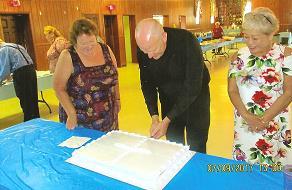 Father Dan cutting the Cake with