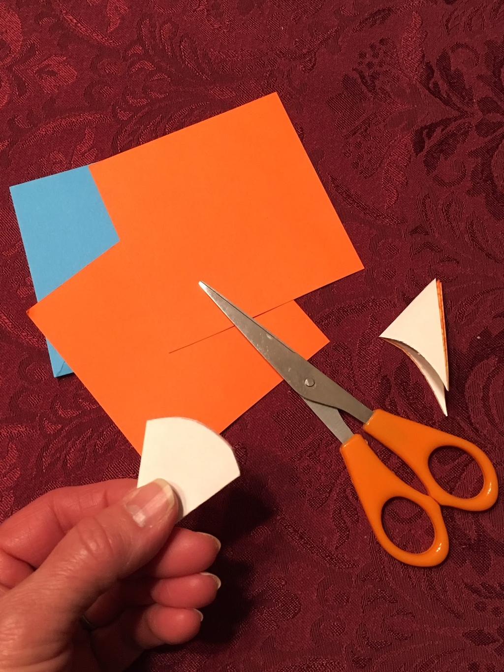 Unfold the paper to reveal an 8-pointed ower!