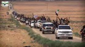 5 Right: Convoy of vehicles as part of the military show. Militiamen waving flags of the organization and the Free Syrian Army.