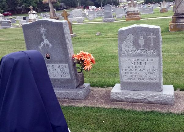 Bartelso, Illinois. Rev. Mother kneels to pray at the grave of Fr.