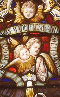 A shepherd prays at the feet of Jesus, and the heavenly hosts of angels sing above. The Star of Bethlehem is directly over the infant Jesus.