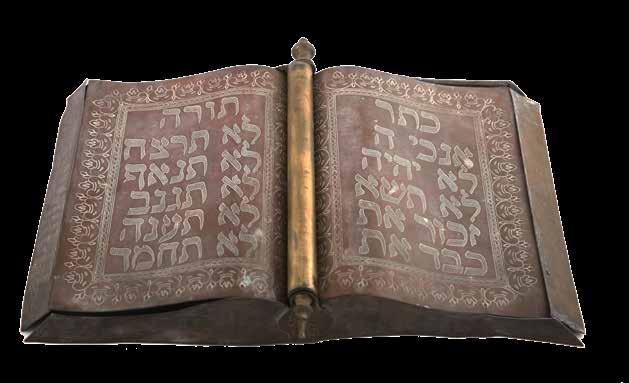 68 Karaite Synagogue Mezuzah Cover. Egypt, 19 20th Century Large, Karaite mezuzah cover. Copper, shaped like a relief of an open book, for use in a synagogue. Egypt, 19th-20th century.