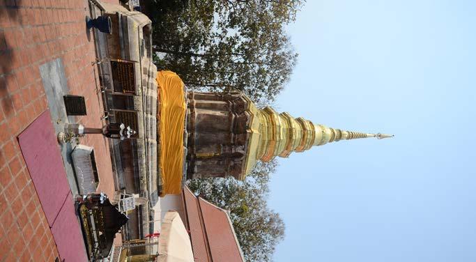 standing image of Buddha on four corners. On the east side of the pagoda there is a recently built monastery that had been made in Larn Na style.