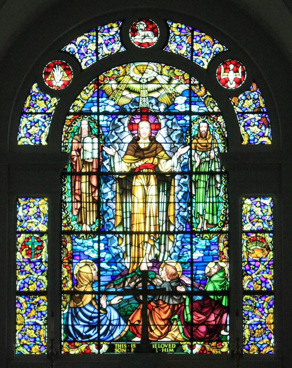 (Chancel Window) Transfiguration of Jesus Matthew 17:5 Christ, the central figure, has Moses on his right representing the law, Elijah on his left representing the prophets, and three disciples