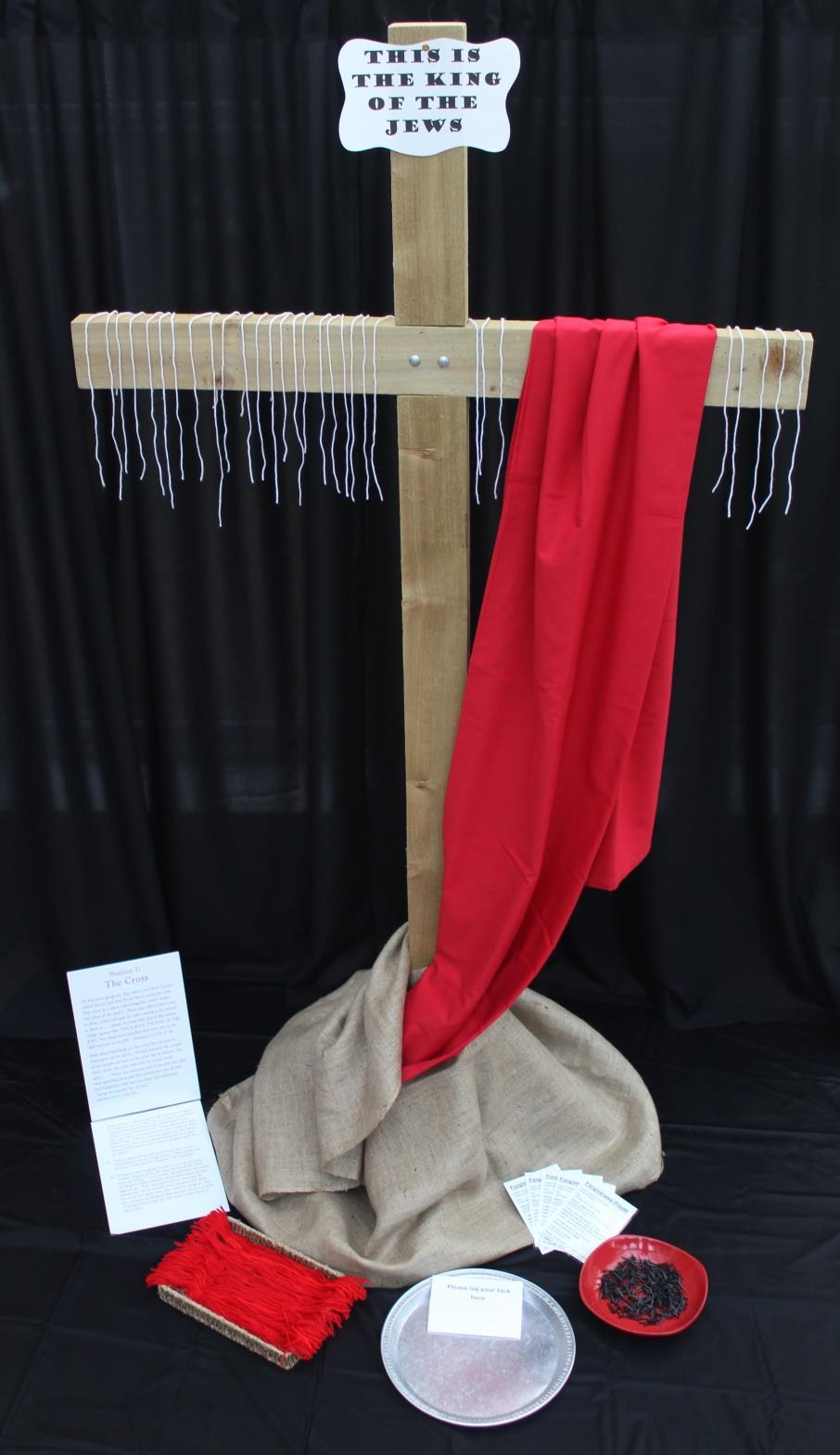 15 Station 7: The Cross Items Needed: A large wooden cross wrapped at the base with a piece of hessian and draped with a piece of red sheeting 28 Notice at the top of the cross, This is the King of
