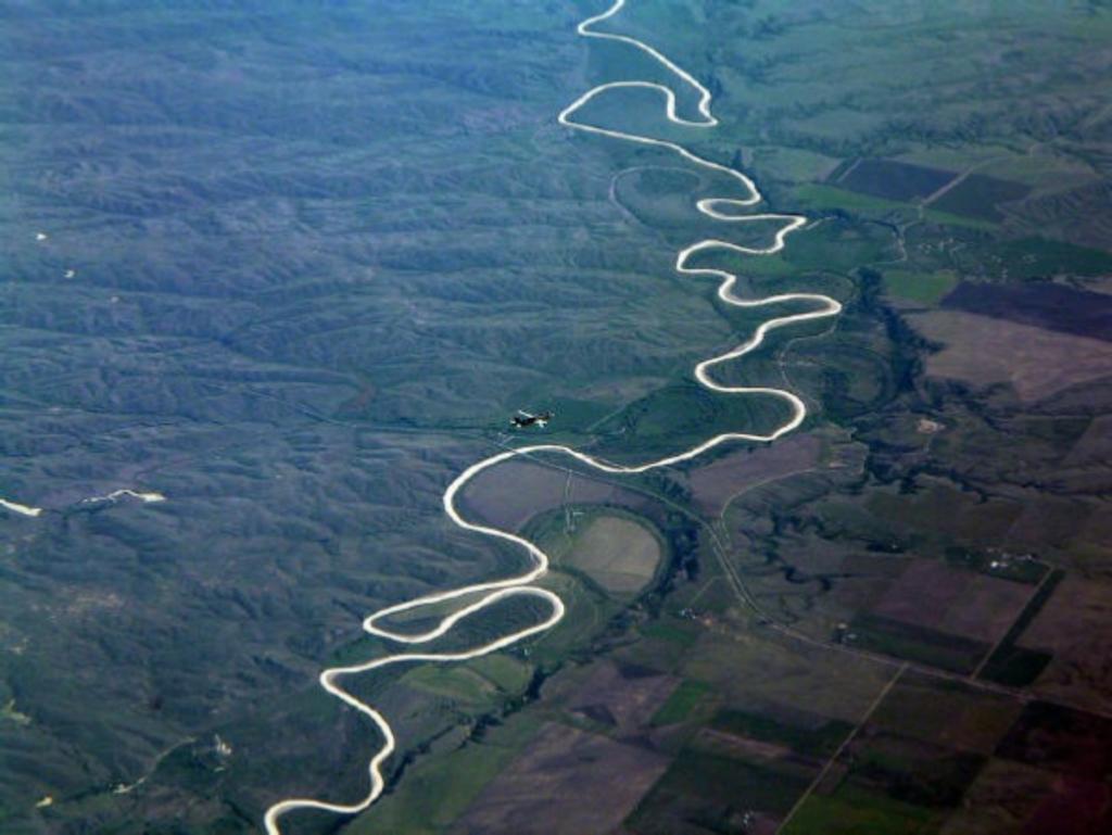 The River Does Not Have to Make Itself Stephanie Sorrell (flying over the Mississippi) The river does not have to make itself Or adhere to the controlled straight lines of matter.