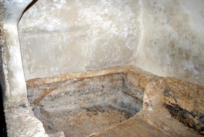 These were separated by a low wall such that, unless the visitor went into the actual burial chamber, he would not see all the wrappings, since the stone recess for the head of the deceased was