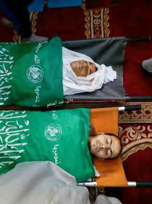 15 Right: The body of Izz al-din Moussa al-sammak wrapped in a green Hamas flag.