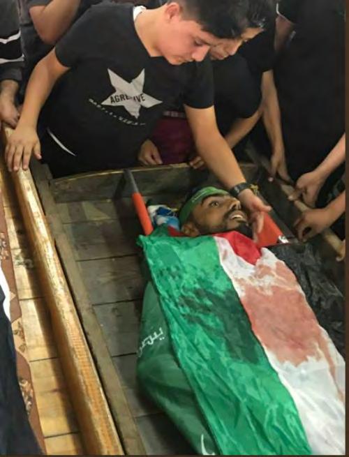 39 Body of Zayid Omar wrapped wearing a Hamas headband, wrapped in a Hamas