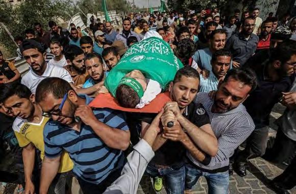 The body of Mahmoud Allyan wrapped in a Hamas flag for burial