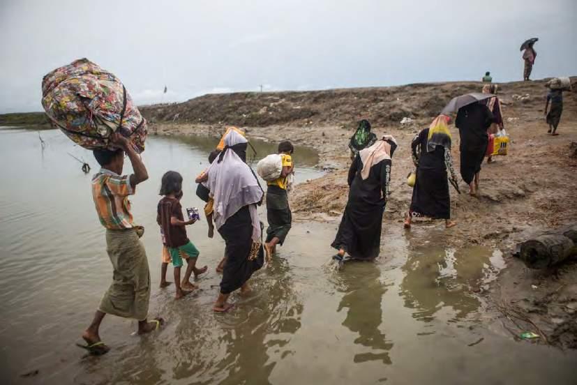 Rohingya refugees arrive to Bangladesh by boat from Myanmar with what few possessions they were able to carry when