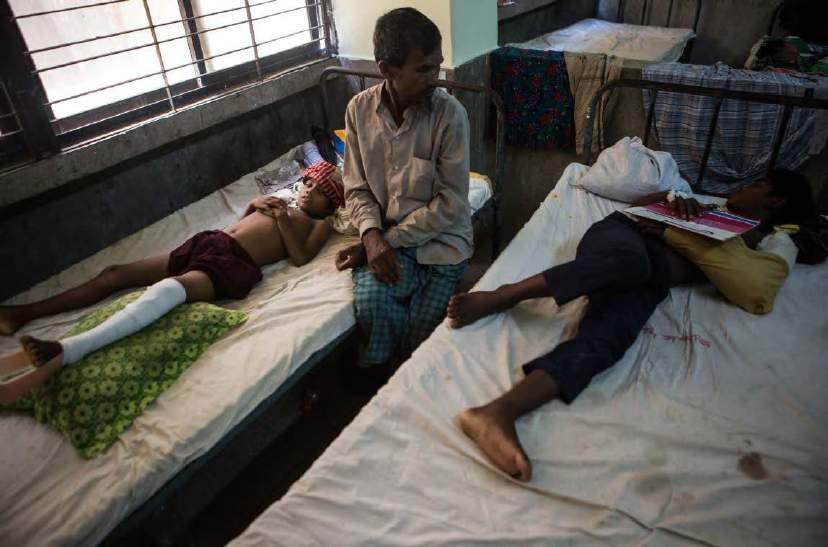Rohingya children lie on cots in the surgical ward of Cox's Bazar District Sadar Hospital, Bangladesh, 1 October 2017.