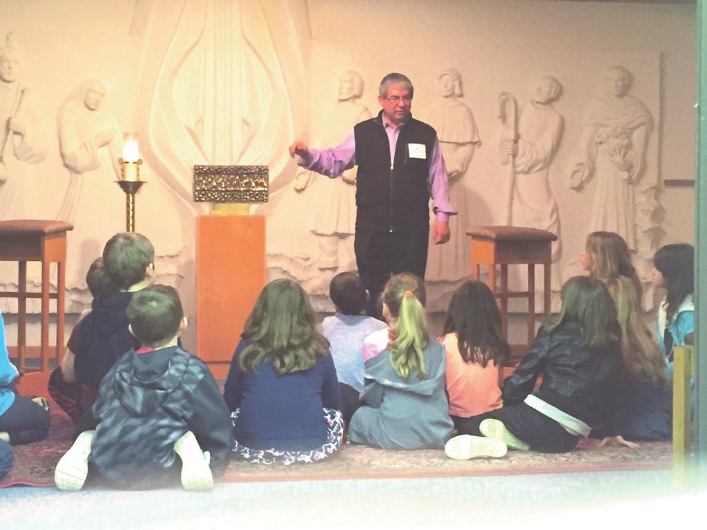 Pictured above is Deacon George Montalvo, Director of Religious Education, who led the children in the prayer station held in Mary s Chapel.