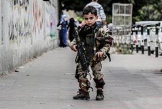 Hamas Lion Cubs The little boy, no older than five, is seen in full military fatigues holding an actual automatic rifle, with the accompanying text reading "these are our