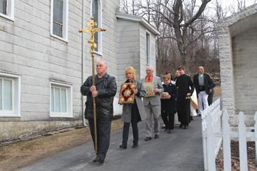 The procession went up the steps to the closed door, with Hutsko tapping on the door with a crucifix before the door was Faithful celebrate the Resurrection of Christ at Easter Sunday services