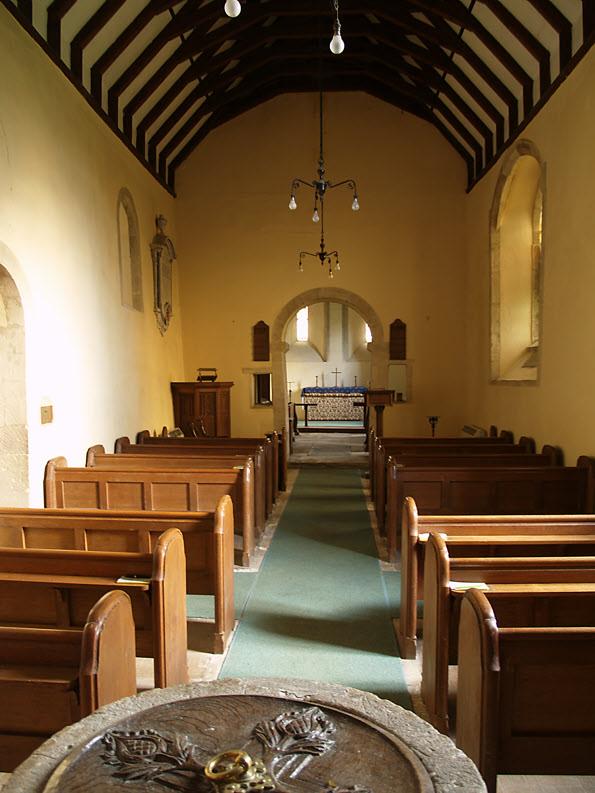 The nave is 12th century and was reroofed at an altered pitch in the 19th. The low, semi-circular chancel arch is also 12th century with large rectangular squints (hagioscopes) either side.