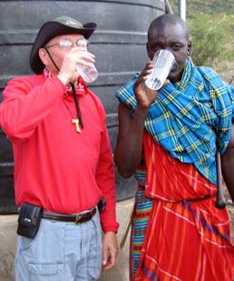Don and Maasai chief take drink together. The well provides water for over 4,000 Maasai and 100,000 head of cattle. Santa Fe Archbishop Michael Sheenan congratulates Don at the national chapter.