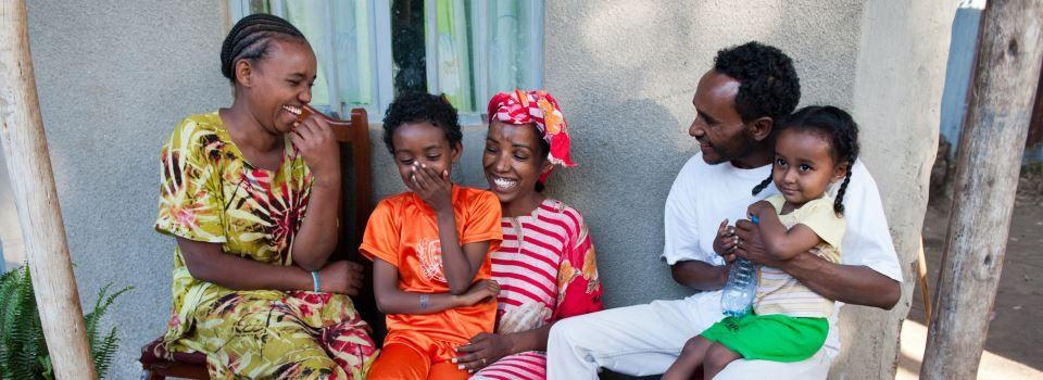 MESERET AT HOME WITH HUSBAND BELAY AND THEIR THREE DAUGHTERS.