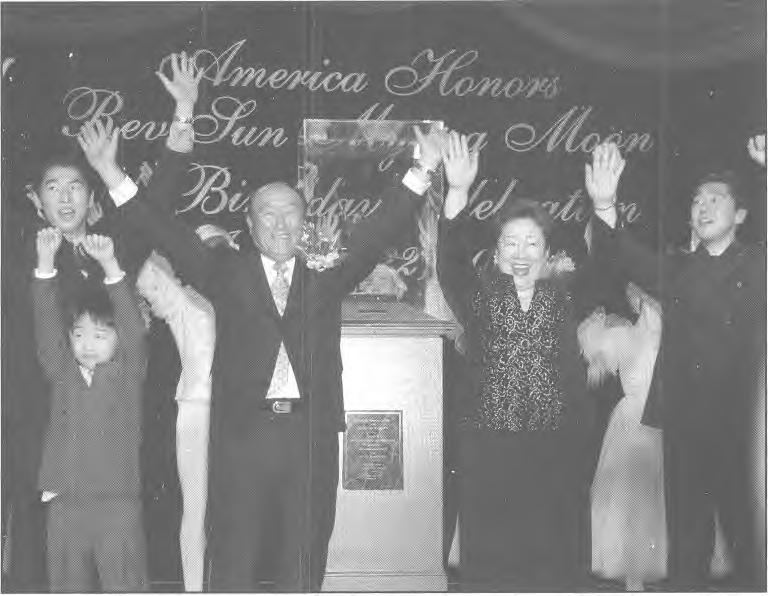 The Path for America and Humanity in the Last Days 7 Reverend and Mrs. Sun Myung Moon together with members of their family cheer at the conclusion of the celebration.