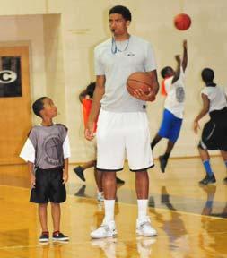 Page 2 One Died for All Basketball Camp in Photos A young camper looks up to James McAdoo Greg
