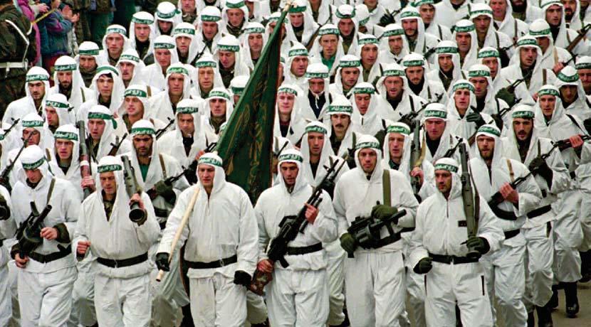 The Roots of the IHH Bosnian government soldiers of the 7th Muslim Brigade parade during the celebration of the third anniversary of the Bosnian Army Third Corps in Zenica, Bosnia, on December 10,