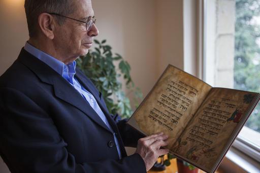 Jewish family makes claims to prized Passover manuscript 21 April 2016, by By Daniel Estrin In this photo taken Wednesday, April 13, 2016, Eli Barzilai holds a copy of the Birds' Head Haggadah in his