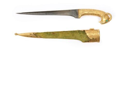 The pommel in the shape of an animal head. The dagger with a straight blade and overall foliate gold overlay and with script on the forte.