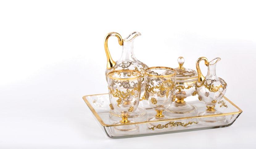 A 5 piece St-Louis glass set طقم سانت لويس مكون من 5 قطع with two glasses, sugar bowl and two pitchers, with gilt painted scrolling foliate decoration and applied glass gilded flowers.