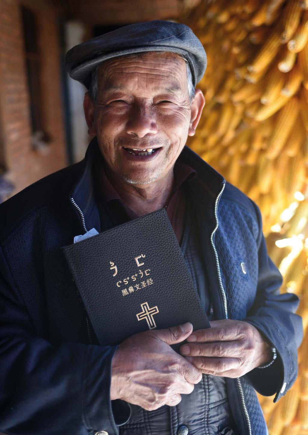 Pastor Zhang Wen Fu, 76, with a copy of the very first Bible in his language, Black Yi,